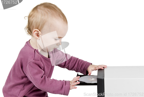 Image of young child playing with CD