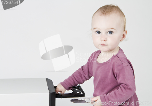 Image of young child playing with CD