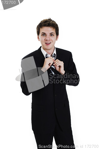 Image of business man adjusting tie
