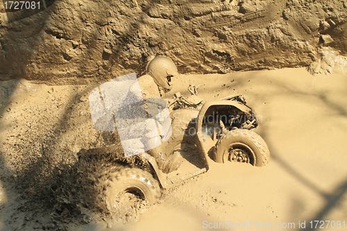 Image of man badly stuck in mud with his quadbike