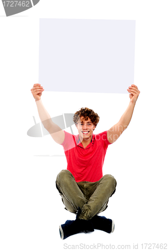 Image of Trendy guy holding advertising board