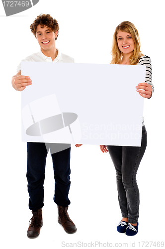 Image of Adorable young couple promoting blank banner ad