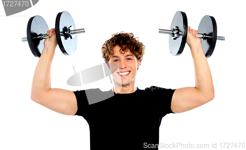 Image of Portrait of a smiling athletes lifting weights