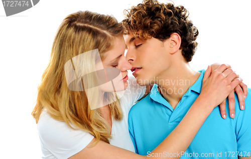 Image of Teenage couple about to kiss each other