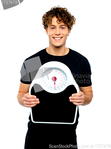 Image of Attractive athlete showing weighing scale