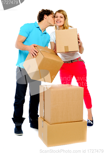 Image of Young couple gently holding cartons