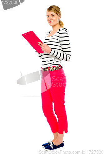 Image of Woman standing with clipboard