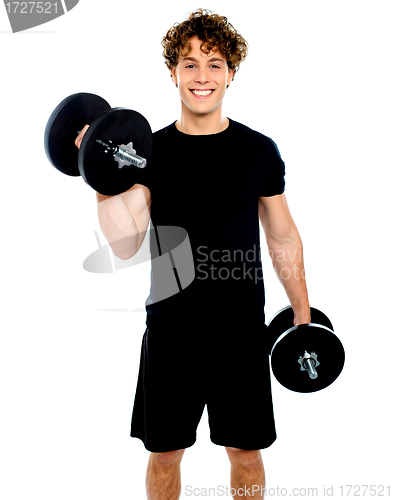 Image of Smiling muscular man doing exercise