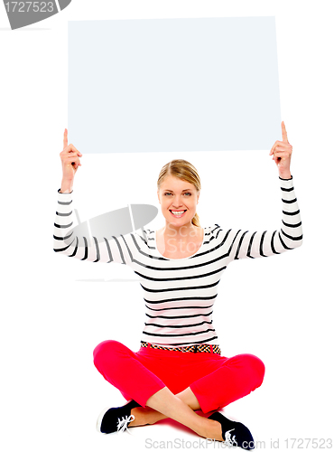 Image of Seated woman showing blank billborad
