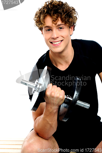Image of Fit trainer doing biceps exercise