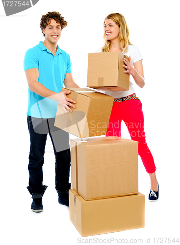 Image of A young couple holds boxes in studio