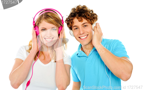 Image of Couple enjoying music through headphones