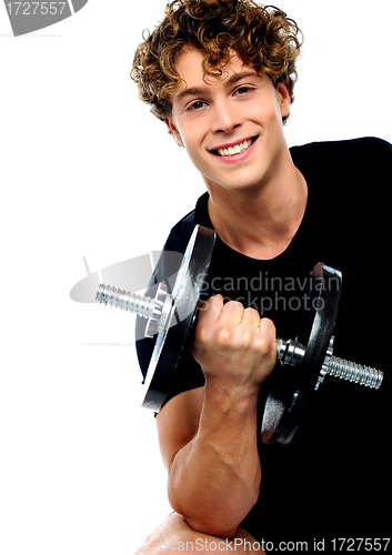 Image of Athlete doing exercise with dumbbell