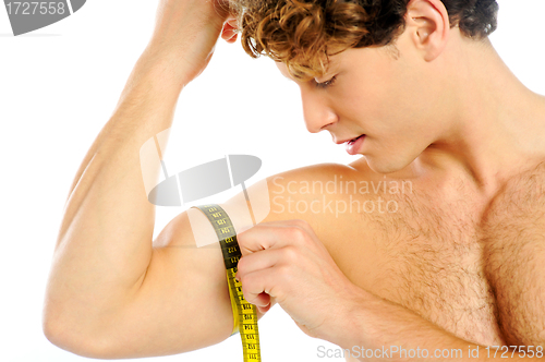 Image of Handsome guy measuring his biceps