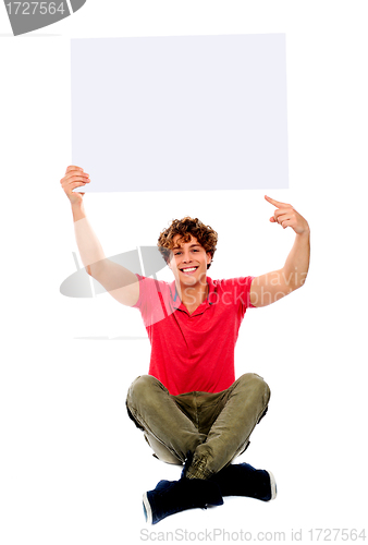 Image of Cool guy pointing towards white blank billboard