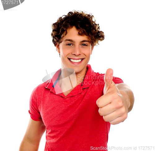 Image of Handsome young man gesturing thumbs-up