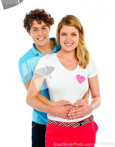 Image of Smiling young couple standing together