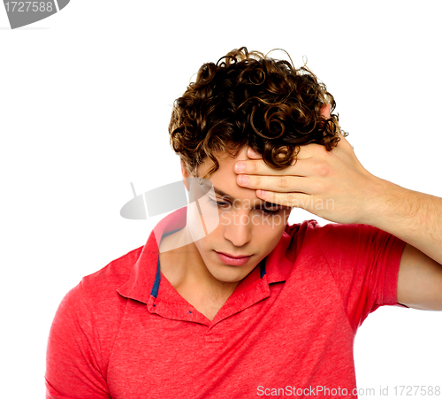 Image of Stressed out guy with hand on his forehead