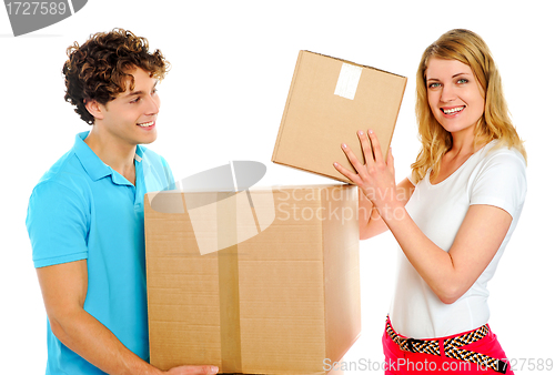 Image of Couple arranging cardboard boxes