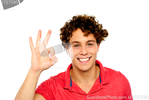 Image of Curly hair guy gesturing excellence sign