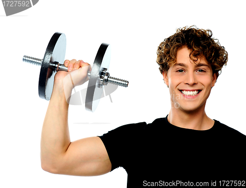 Image of Powerful muscular young man lifting weight