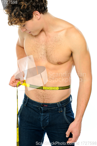 Image of Muscular man measuring his waist