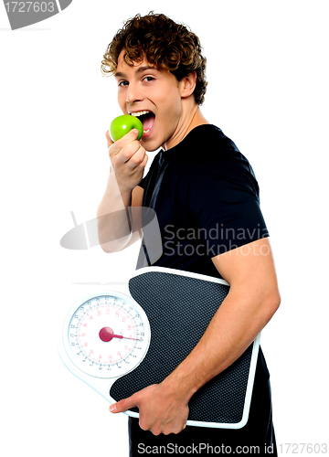 Image of Smart boy eating green apple