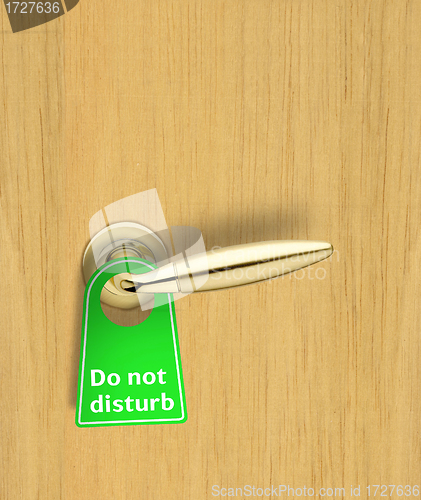 Image of Hotel wood door with a Do not disturb sign