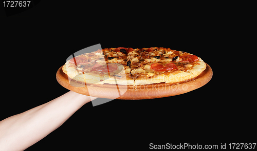 Image of Tasty pizza in wooden plate