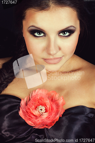 Image of Young beautiful woman with rose