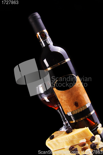 Image of wine bottle with glass and cheese