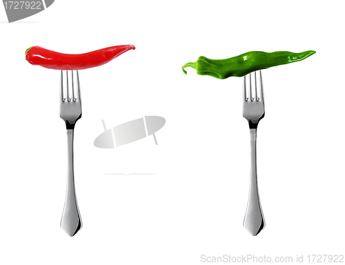 Image of Red hot chili pepper with green pepper pricked on forks