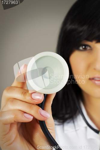 Image of Close up - hand of a doctor holding stethoscope