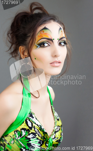 Image of beautiful girl in green dress and with indian make up