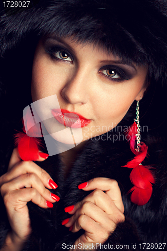 Image of Beautiful young woman wearing fur hat