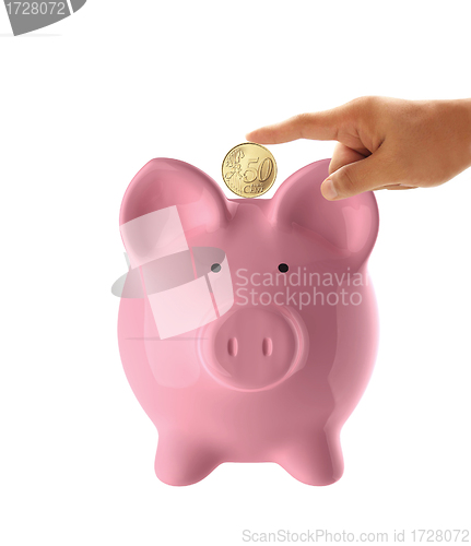 Image of Hand putting coin into the pink piggy bank