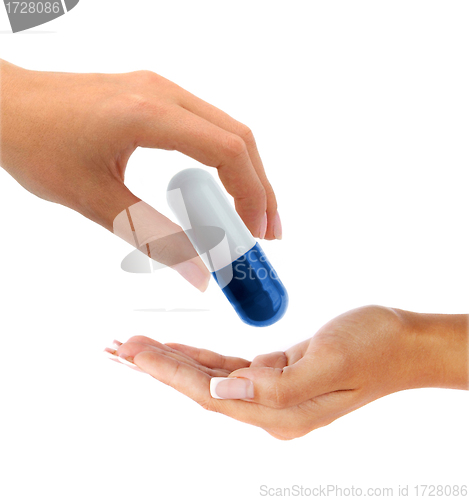 Image of hand gives a big pill