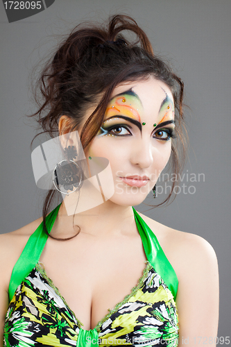 Image of beautiful girl in green dress and with indian make up