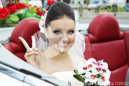 Image of Portrait of the bride sitting in the car