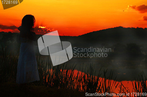 Image of Girl in red sunset