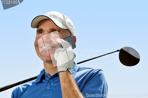 Image of Golfer using mobile phone
