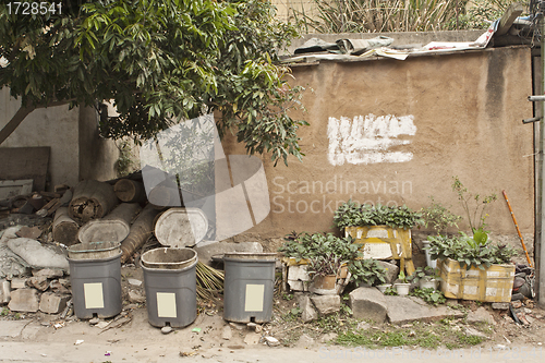 Image of Chinese village with houses and rubbish bins