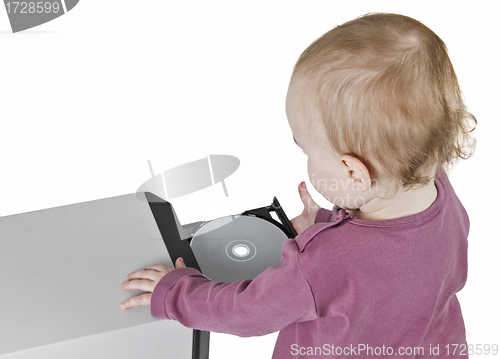 Image of young child playing with CD