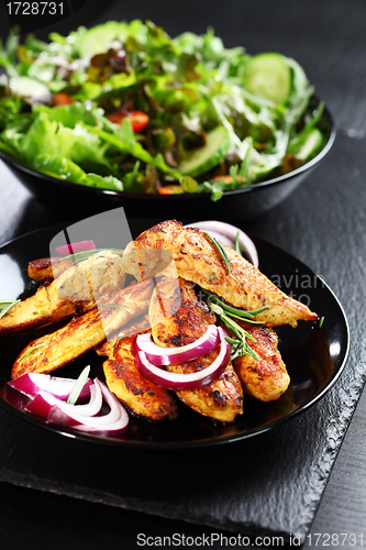 Image of Marinated chicken breast stripes with salad