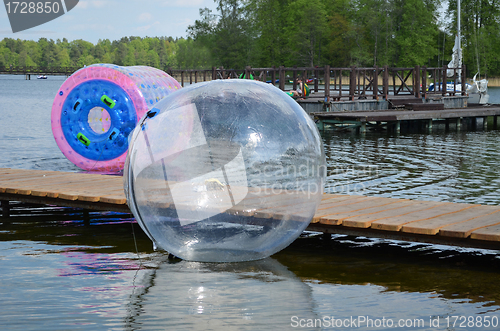 Image of Zorbing air bubbles on water. Pier lake Trakai 
