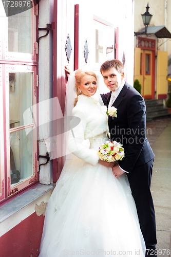Image of beautiful groom and the bride on the street of old town