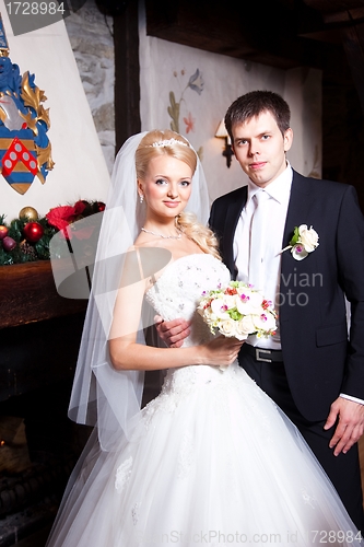 Image of beautiful groom and bride in interior