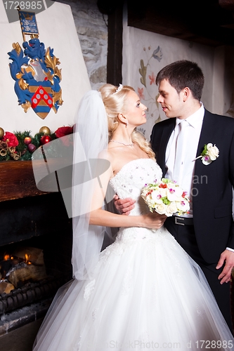 Image of beautiful groom and bride in interior