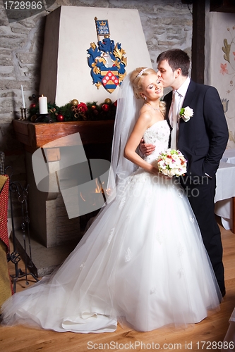 Image of beautiful groom and bride in interior