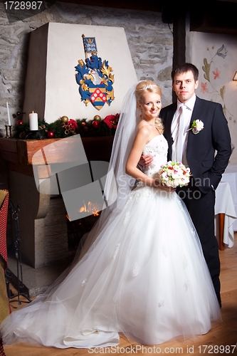 Image of beautiful groom and bride in interior